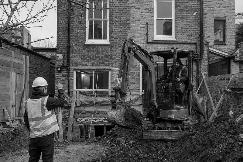 Compact excavator operating on a refurbishment site